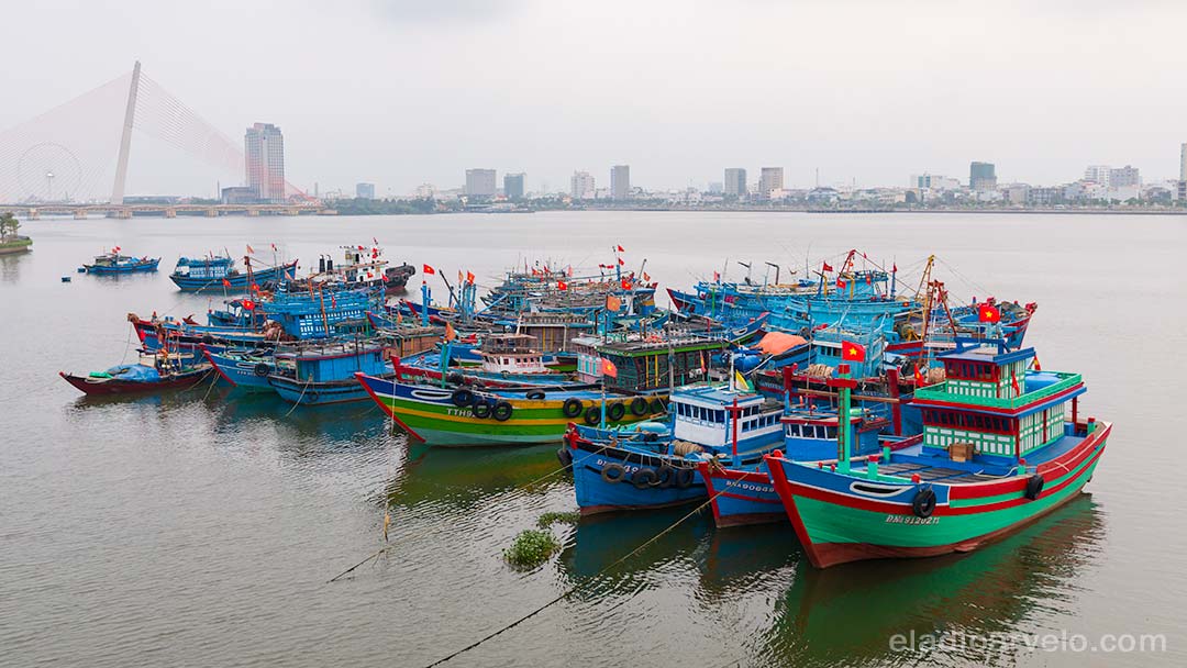 Colorful fishing boats anchored together in Da Nang.